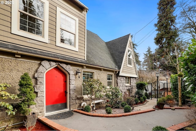 view of side of home with stone siding