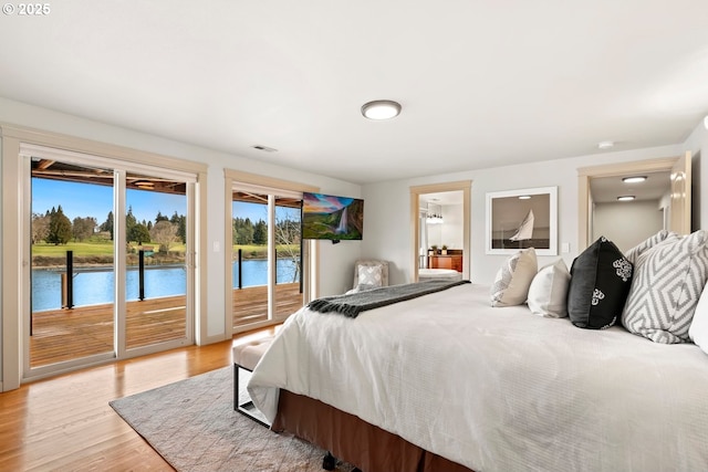 bedroom featuring access to exterior and light wood-type flooring