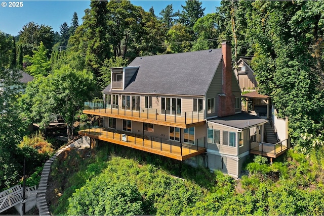 10150 S Riverside Dr, Portland, OR 97219 - rear view of house featuring a chimney, a balcony, roof with shingles, and view of scattered trees