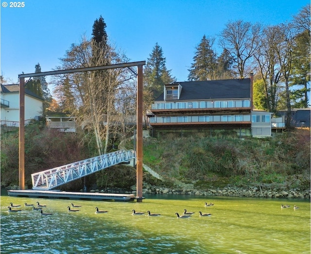 exterior space featuring a lawn and a water view