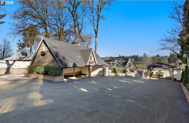 view of side of property with a gazebo