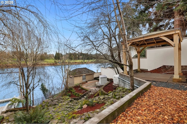 exterior space with a gazebo and a water view