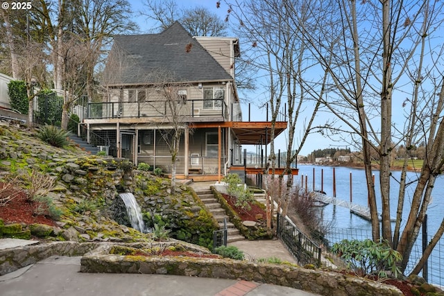 10150 S Riverside Dr, Portland, OR 97219 - view of front of house with stairway, a shingled roof, and a deck with water view