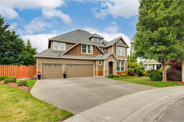 1551 S 14th Cir, Ridgefield, WA 98642 - view of front of home featuring concrete driveway, stone siding, roof with shingles, and an attached garage