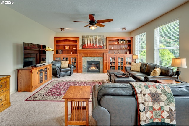 1551 S 14th Cir, Ridgefield, WA 98642 - carpeted living area with a fireplace, a ceiling fan, and a textured ceiling