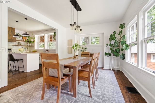 2340 SW Dolph Ct, Portland, OR 97219 - dining room with dark wood-type flooring, a chandelier, and baseboards