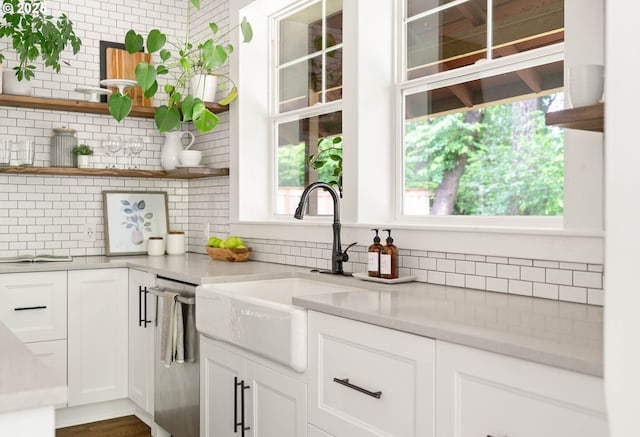 2340 SW Dolph Ct, Portland, OR 97219 - kitchen with stainless steel dishwasher, a sink, open shelves, and backsplash