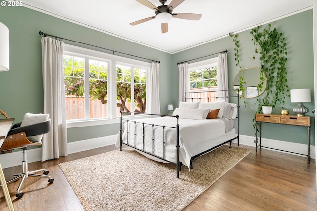 2340 SW Dolph Ct, Portland, OR 97219 - bedroom with ornamental molding, baseboards, wood finished floors, and ceiling fan