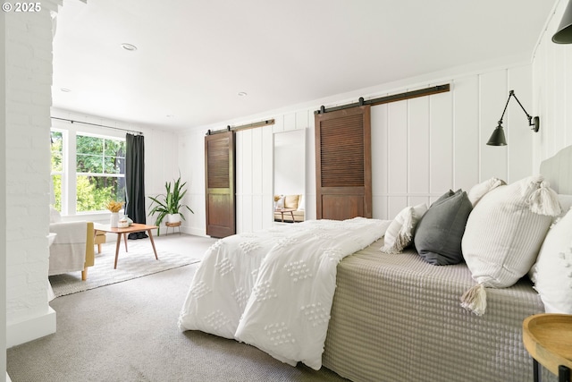 2340 SW Dolph Ct, Portland, OR 97219 - bedroom featuring a barn door and carpet flooring