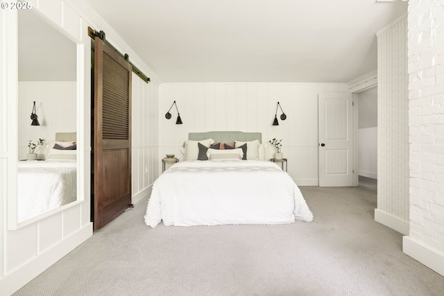 2340 SW Dolph Ct, Portland, OR 97219 - bedroom with a barn door and carpet
