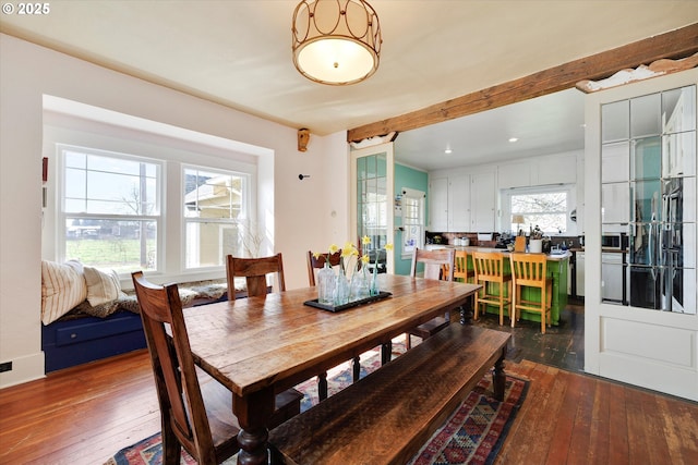 dining space with recessed lighting, beamed ceiling, and hardwood / wood-style flooring