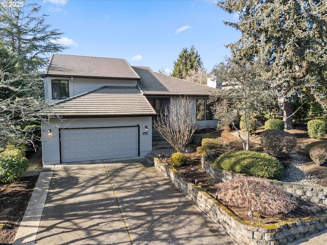 view of front of home with a garage, driveway, and a tiled roof