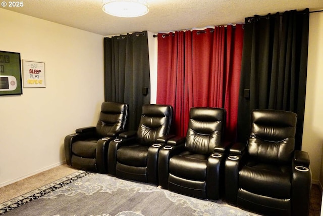 carpeted home theater featuring baseboards