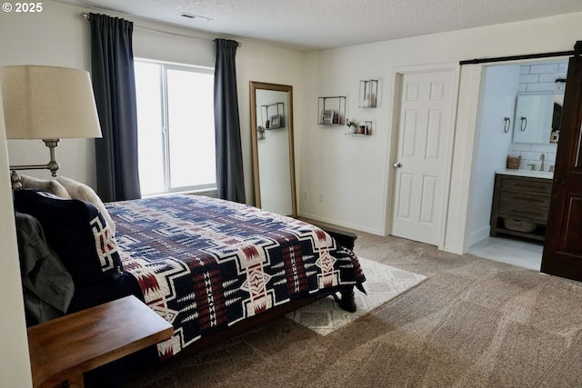 bedroom featuring carpet flooring, a textured ceiling, and visible vents