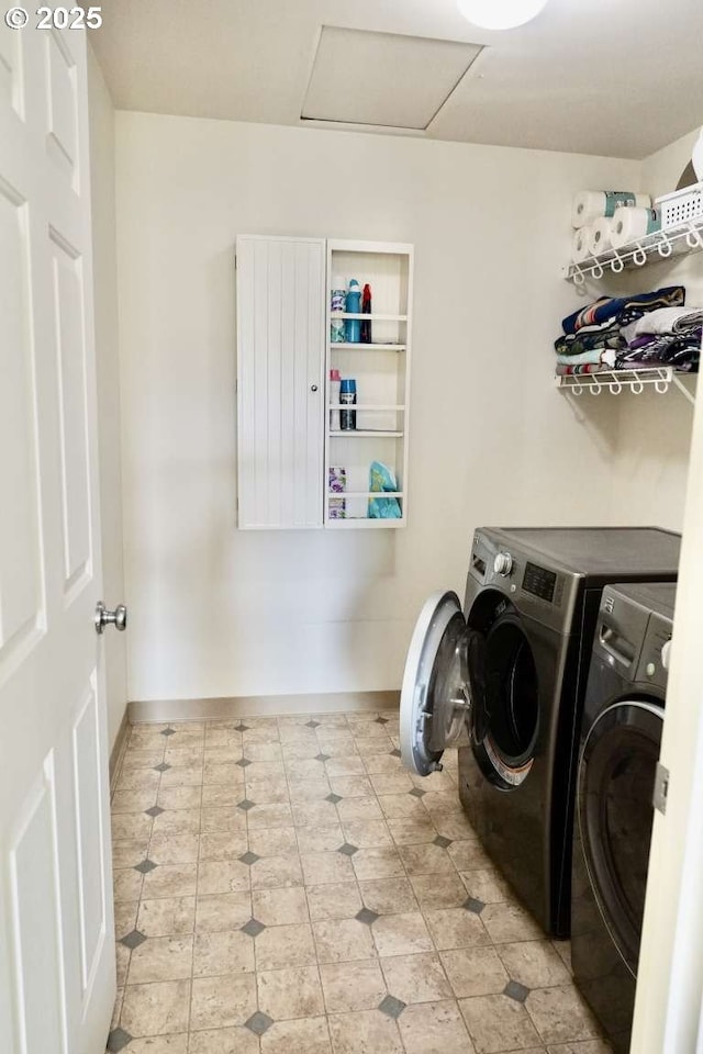 laundry room with laundry area, washer and clothes dryer, attic access, and baseboards