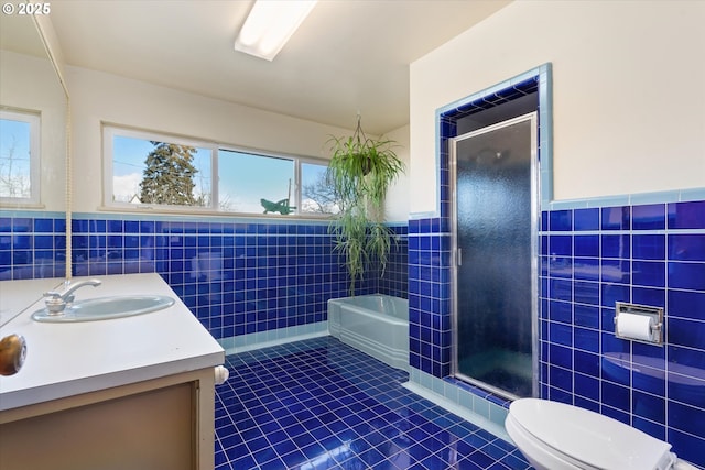 full bathroom with tile walls, vanity, tile patterned flooring, and toilet