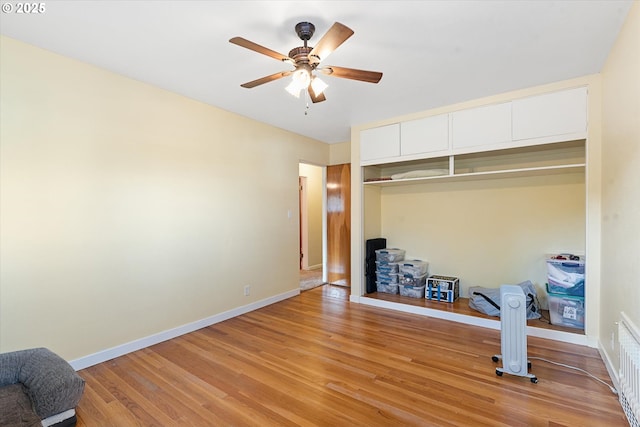 unfurnished bedroom featuring ceiling fan, light hardwood / wood-style floors, and a closet