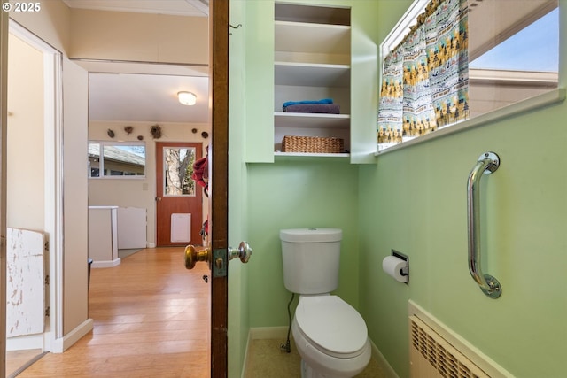 bathroom featuring wood-type flooring and toilet