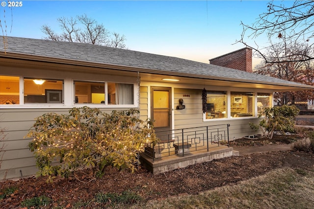 back house at dusk with covered porch