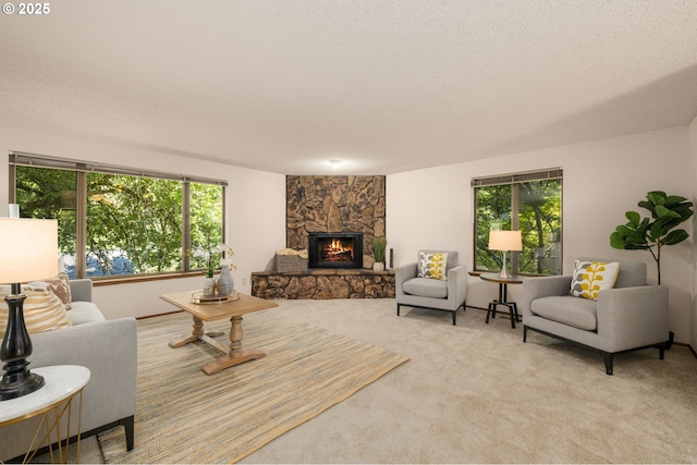 6416 SW 33rd Pl, Portland, OR 97239 - living area featuring a stone fireplace, light colored carpet, and a textured ceiling