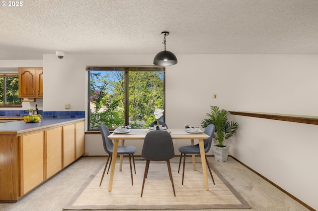 6416 SW 33rd Pl, Portland, OR 97239 - dining space featuring light colored carpet, a textured ceiling, and healthy amount of natural light