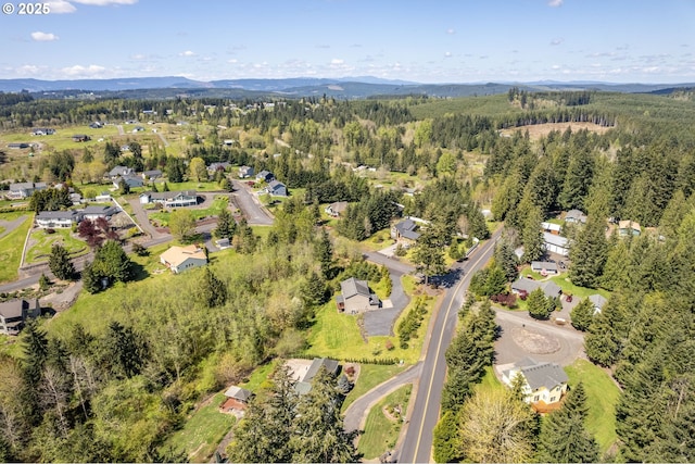 bird's eye view featuring a view of trees, a mountain view, and a residential view