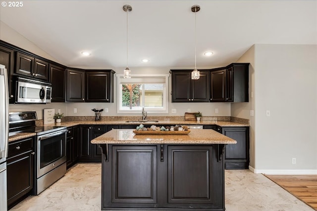kitchen featuring a sink, stainless steel appliances, pendant lighting, marble finish floor, and a kitchen island