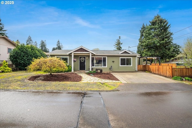 ranch-style home with fence and concrete driveway