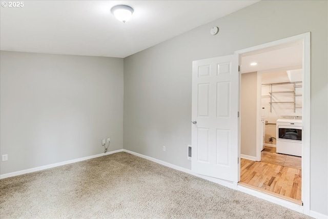 empty room with washer / clothes dryer and baseboards