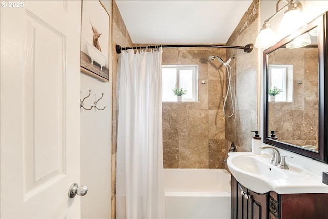 bathroom featuring shower / bathtub combination with curtain and vanity