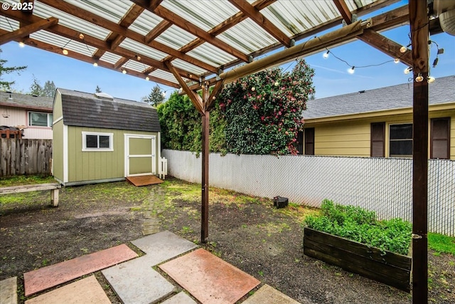 view of yard featuring a storage shed, an outbuilding, a fenced backyard, and a pergola