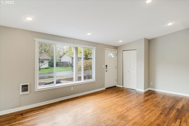 foyer entrance featuring baseboards, recessed lighting, vaulted ceiling, and wood finished floors