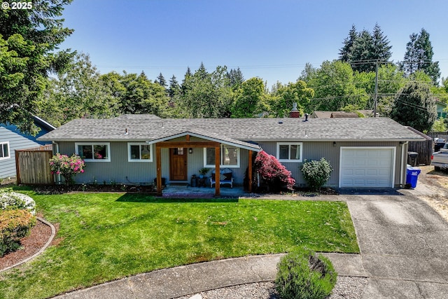 ranch-style house with an attached garage, asphalt driveway, a front lawn, roof with shingles, and covered porch
