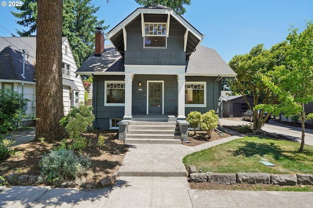 3216 NE 52nd Ave, Portland, OR 97213 - bungalow featuring a porch, a shingled roof, and a chimney