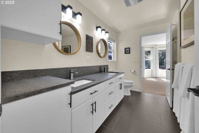 88005 Windleaf Way, Florence, OR 97439 - full bathroom featuring tile patterned flooring, double vanity, visible vents, toilet, and a sink