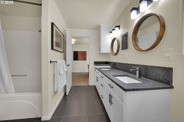 88005 Windleaf Way, Florence, OR 97439 - bathroom with tile patterned floors, a sink, double vanity, shower / bathtub combination, and baseboards