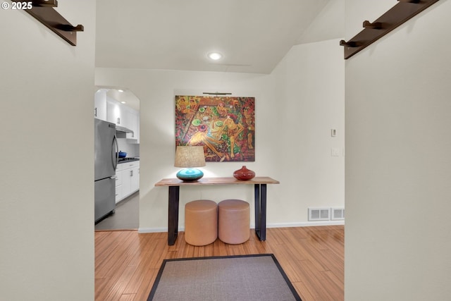 88005 Windleaf Way, Florence, OR 97439 - interior space featuring white cabinets, freestanding refrigerator, light wood-style floors, and visible vents