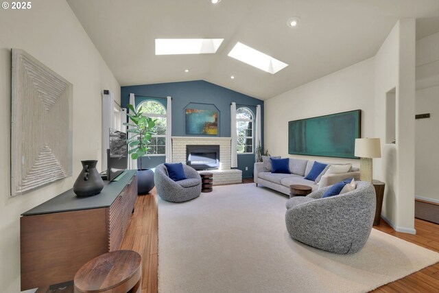 88005 Windleaf Way, Florence, OR 97439 - living room with recessed lighting, vaulted ceiling with skylight, wood finished floors, and a brick fireplace