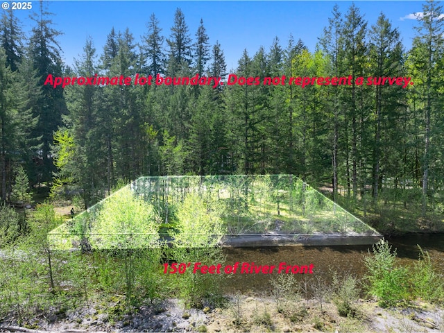 view of yard with a view of trees
