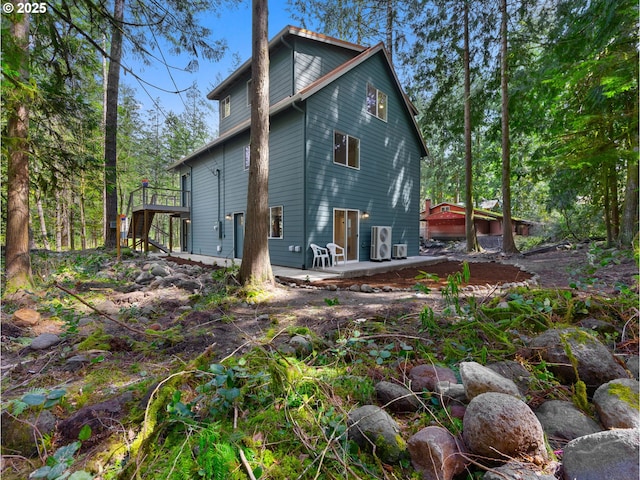 rear view of property with a patio area, stairway, and a deck