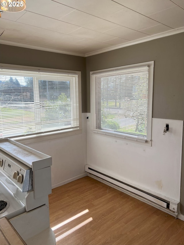76464 High St, Oakridge, OR 97463 - washroom with baseboard heating, ornamental molding, healthy amount of natural light, and light wood-style flooring