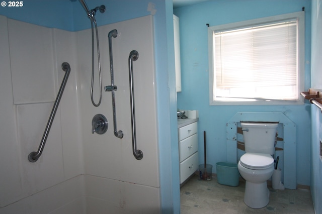 bathroom featuring a shower and toilet
