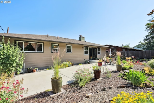 1900 E 10th St, The Dalles, OR 97058 - back of house featuring a patio area and a chimney