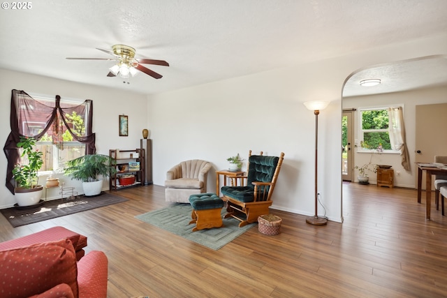 1900 E 10th St, The Dalles, OR 97058 - living room with ceiling fan, wood finished floors, and arched walkways