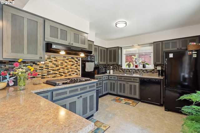 1900 E 10th St, The Dalles, OR 97058 - kitchen with black appliances, under cabinet range hood, gray cabinetry, a sink, and light countertops