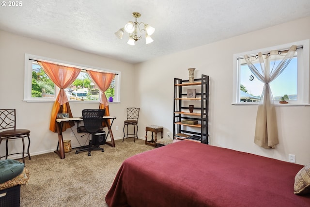 1900 E 10th St, The Dalles, OR 97058 - bedroom featuring a chandelier, carpet floors, a textured ceiling, and baseboards