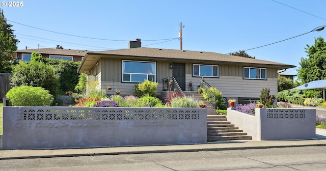1900 E 10th St, The Dalles, OR 97058 - view of front of house with board and batten siding, a chimney, and stairway