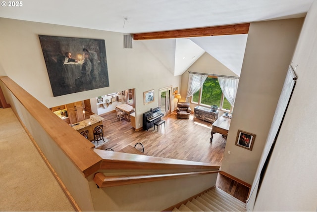 4069 Post Canyon Dr, Hood River, OR 97031 - staircase featuring beamed ceiling, wood finished floors, high vaulted ceiling, and baseboards