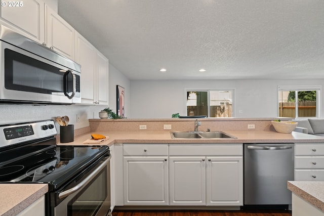1608 NE 154th St, Vancouver, WA 98686 - kitchen featuring appliances with stainless steel finishes, a sink, light countertops, white cabinets, and recessed lighting