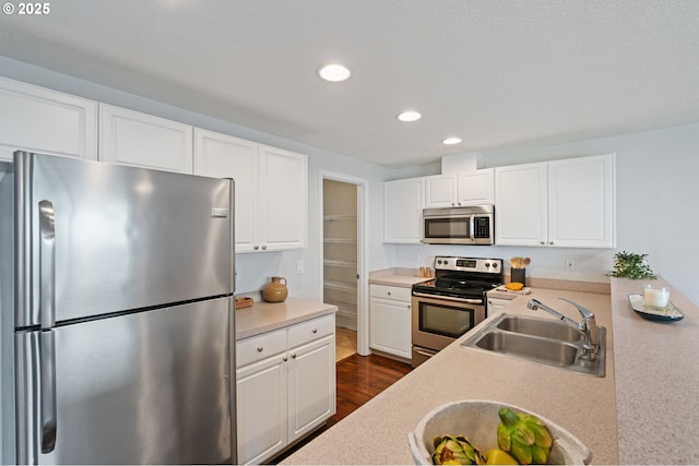 1608 NE 154th St, Vancouver, WA 98686 - kitchen with stainless steel appliances, a sink, recessed lighting, light countertops, and white cabinetry